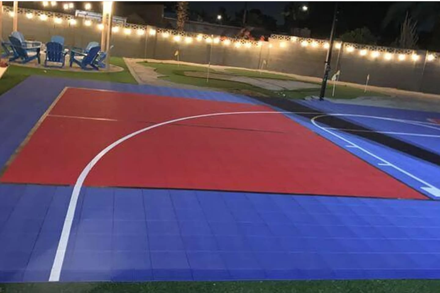 String lights strung overhead, lounge chairs just off the court — built for late-night games and even later conversations.