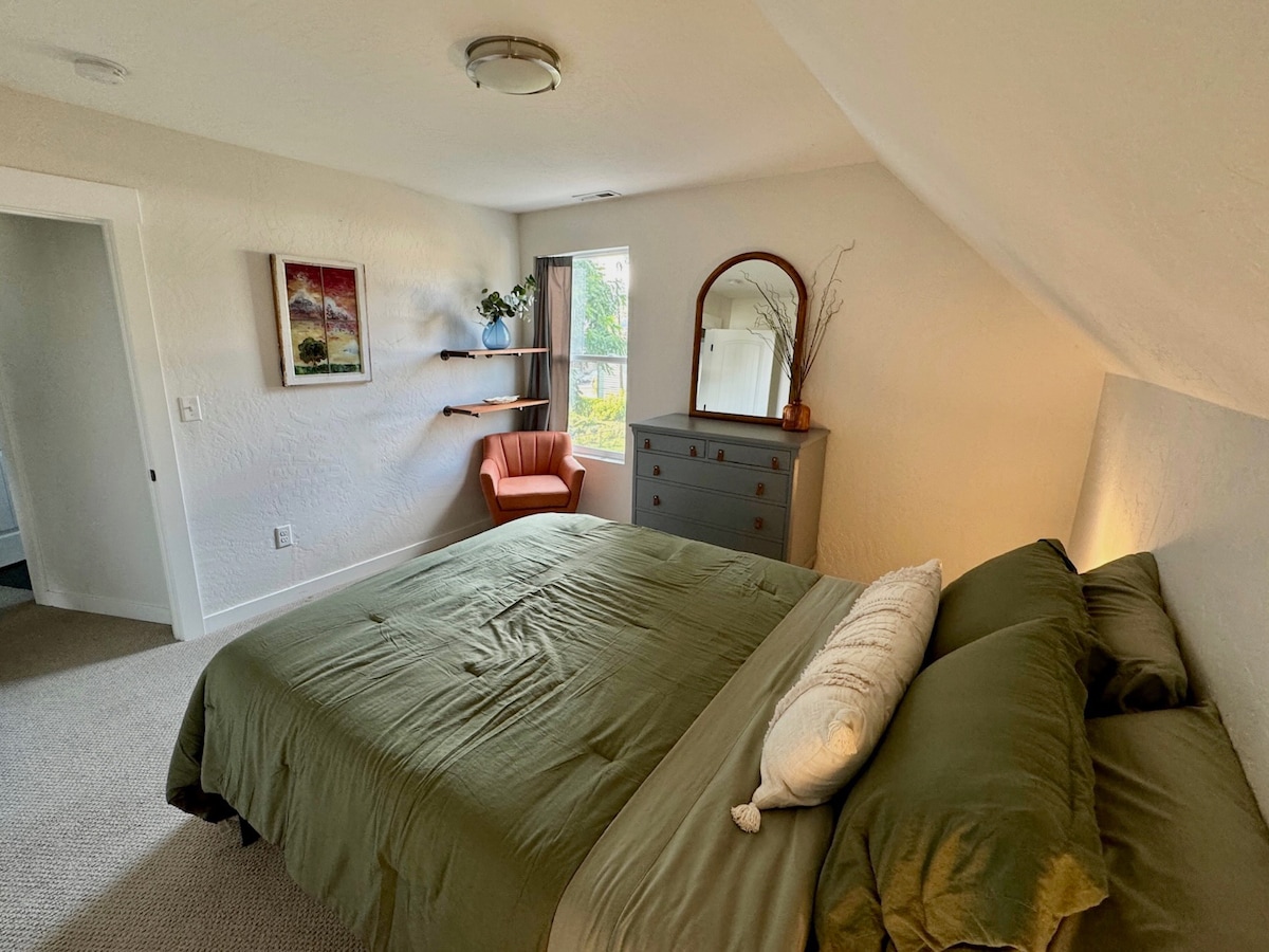This bedroom features a queen bed, black out curtain, and a generous walk-in closet space. 