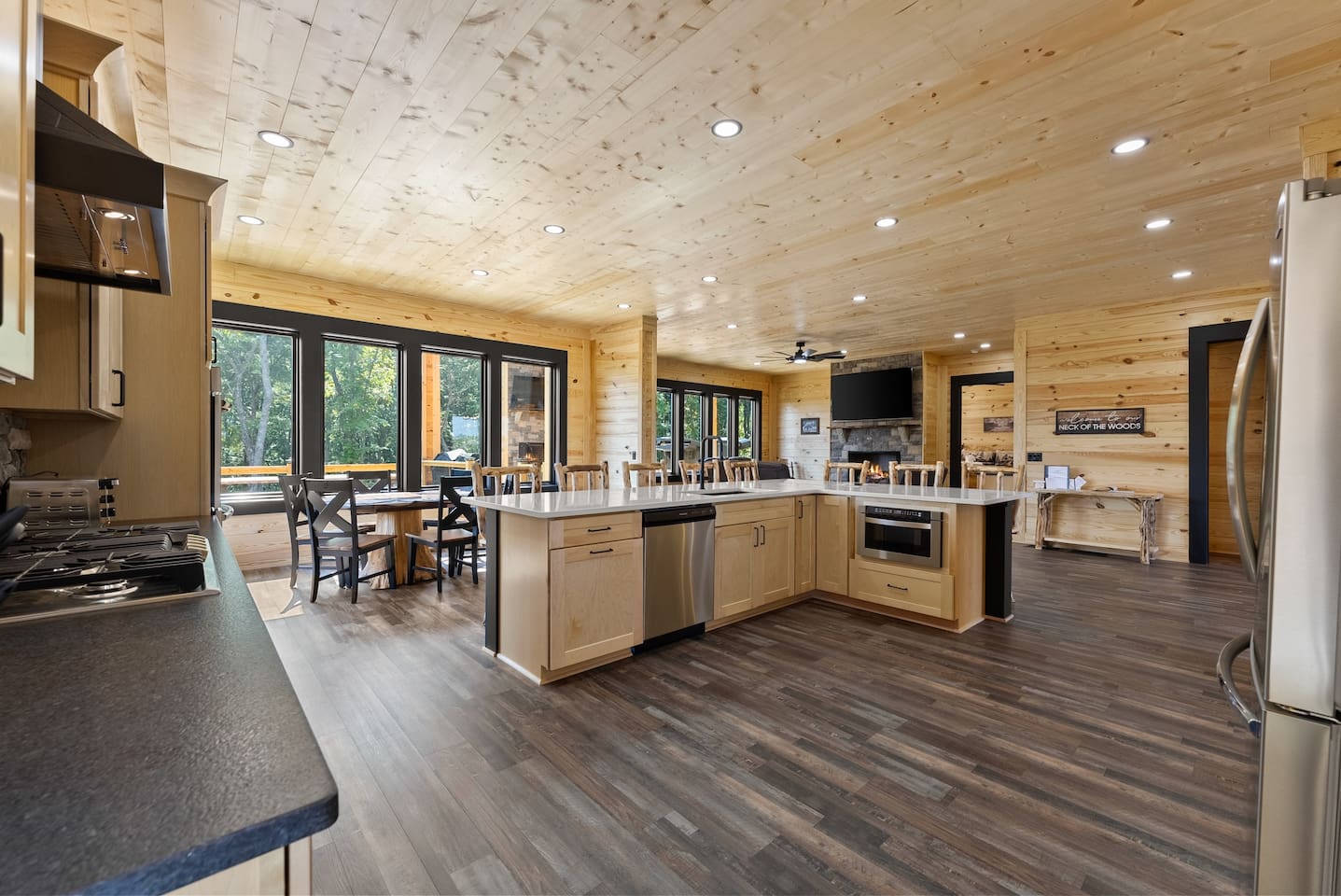  Floor-to-ceiling windows flood the kitchen and dining space with natural light and serene forest views—ideal for cooking and connecting.
