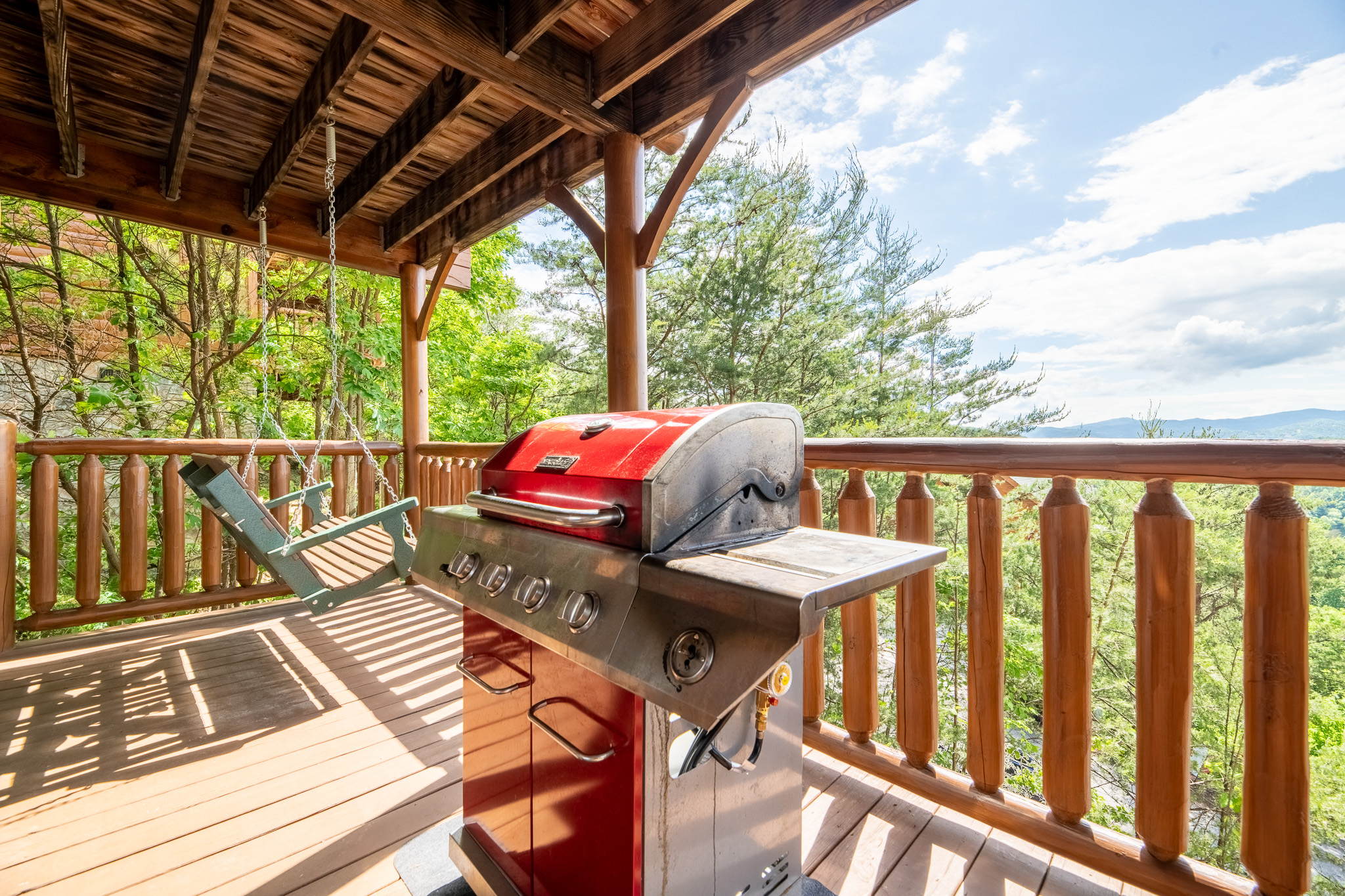 Fair warning — whoever claims the porch swing first isn't giving it up. Mountain views, tree canopy, and a breeze that makes you forget what day it is.