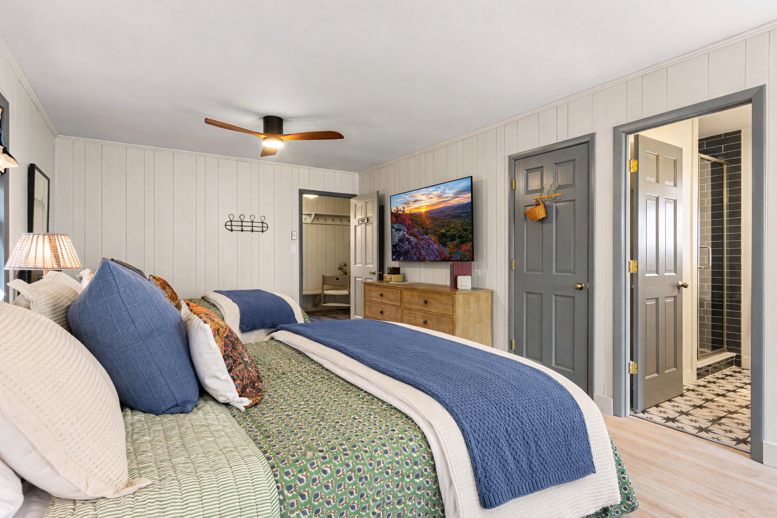 Located just off the front entry foyer, the Fisherman’s Room offers privacy from the rest of the home and includes a full ensuite bathroom—featuring tile lovingly laid with help from our then-12-year-old son during the renovation.