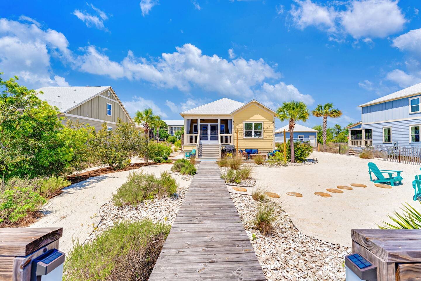 Private boardwalk leads you to this beautiful beach house surrounded by tropical landscaping and white sandy grounds