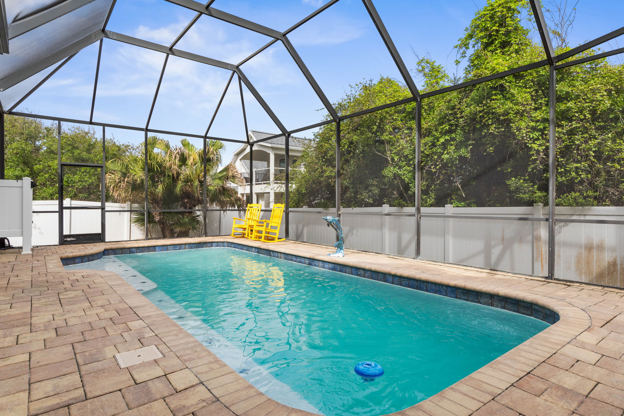 Spend slow mornings in the yellow rockers, slip into the pool when the sun gets high, and come back from the beach to a private screened oasis that makes every day feel lighter, longer, and exactly how vacation should feel.