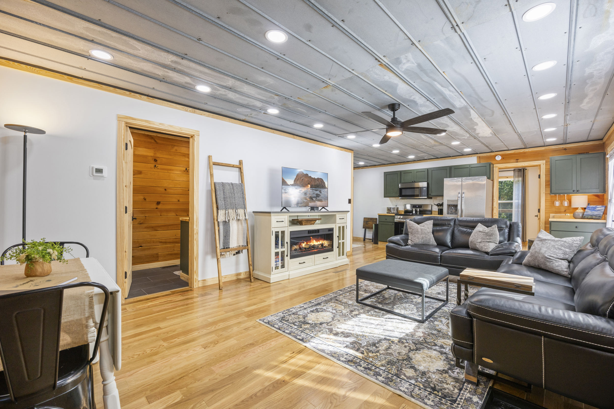 Open-concept living room with fireplace, smart TV, and plenty of seating to relax.