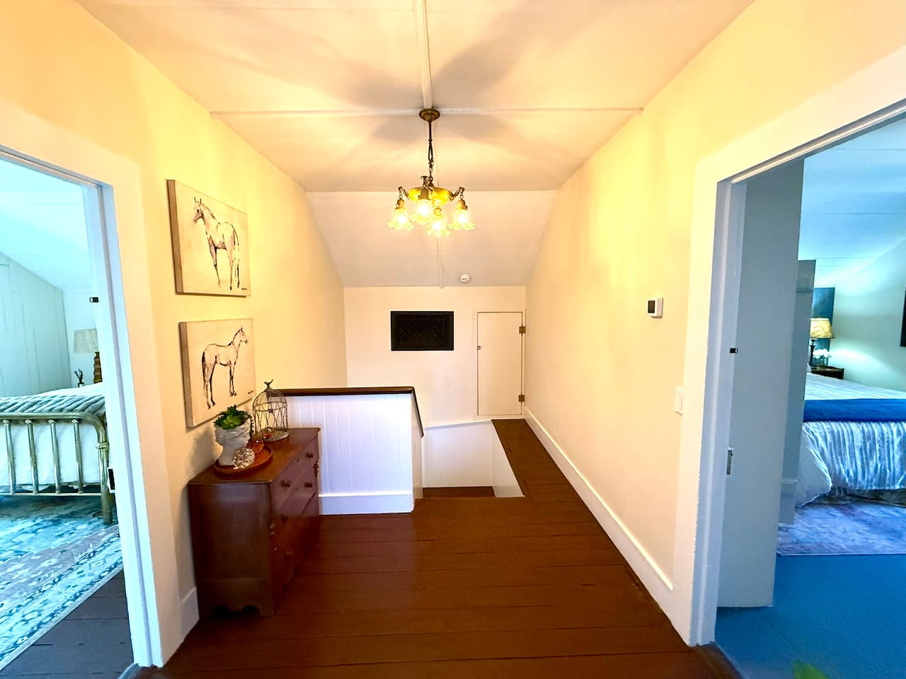 At the top of the stairs, two bedrooms share a full bath and spacious landing, creating a comfortable retreat for family or friends. Vintage and custom lighting add character, while a separate thermostat keeps the whole floor just right.
 