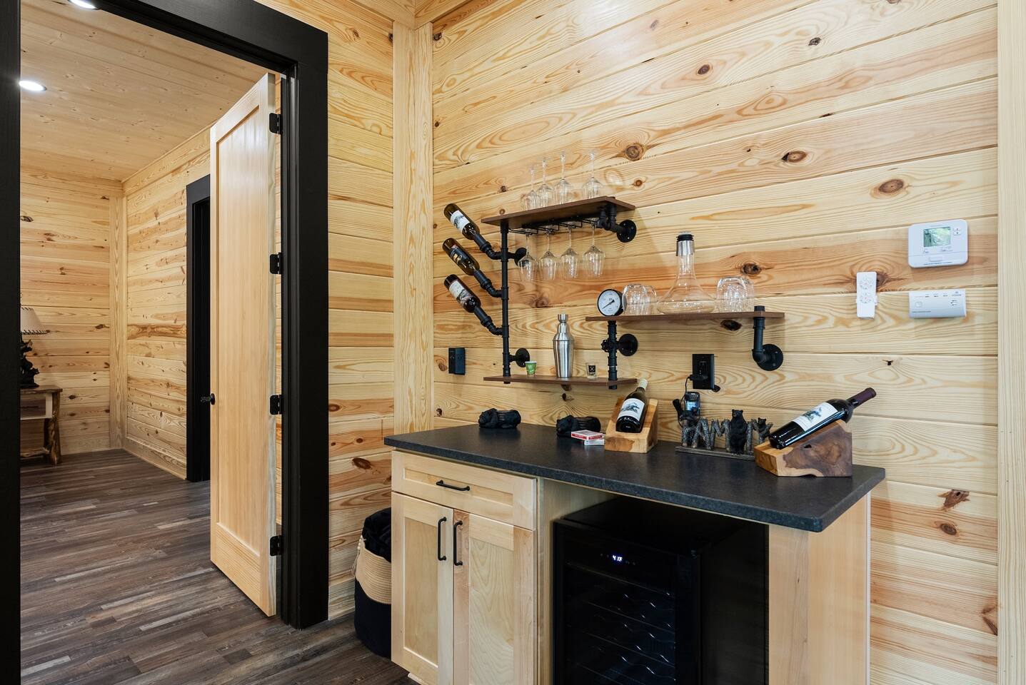 Elevate your evenings with wine and cocktails from the built-in bar—complete with a wine fridge, glassware, and artisan shelving.