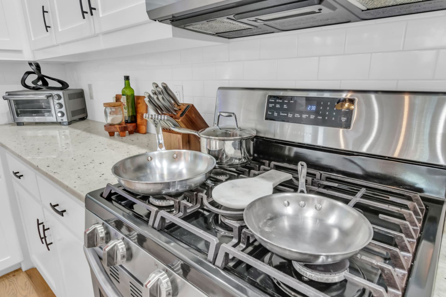 Stainless steel range with sleek cooktop for gourmet meals.