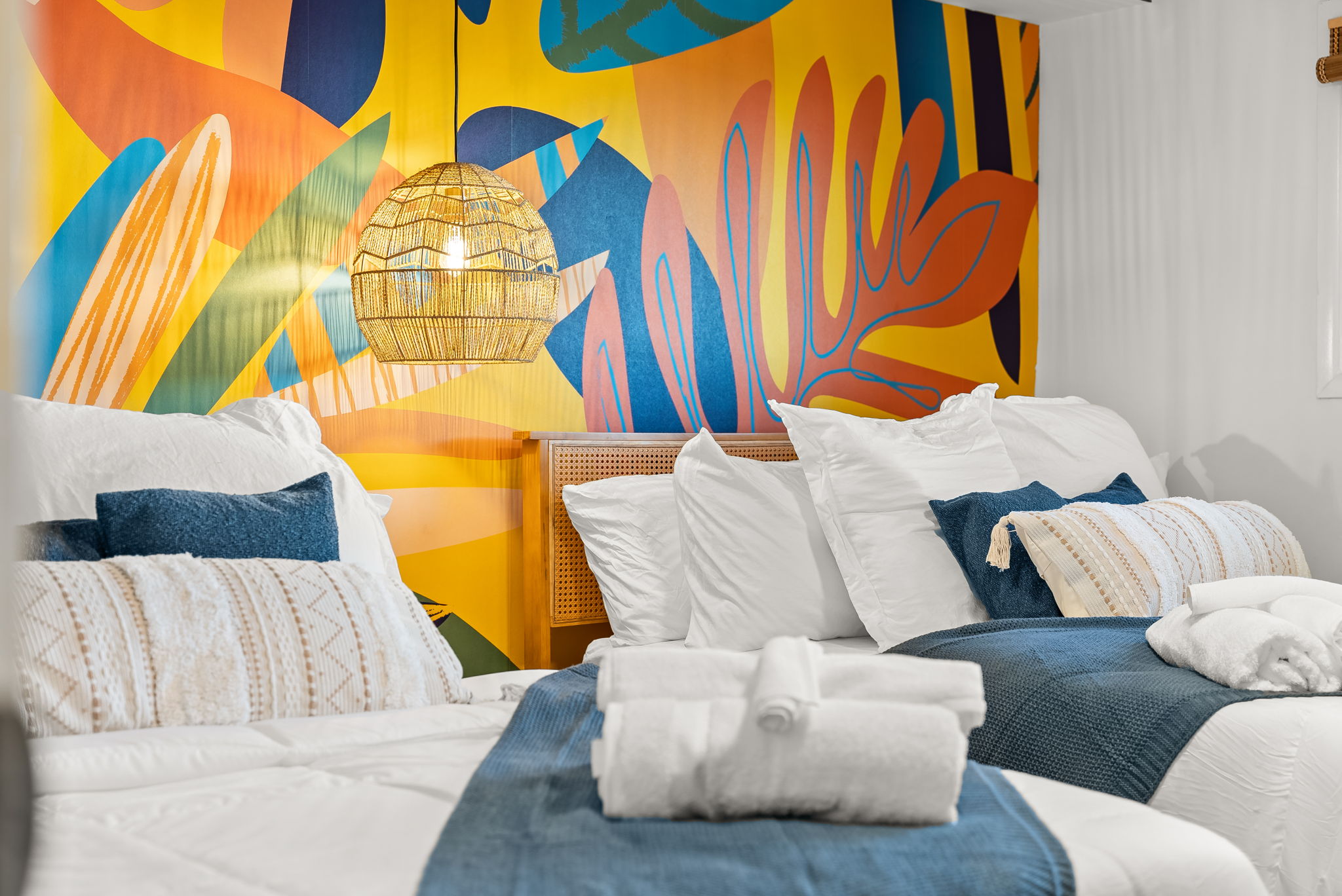 Bright tropical feel accent wall makes for an uplifting retreat