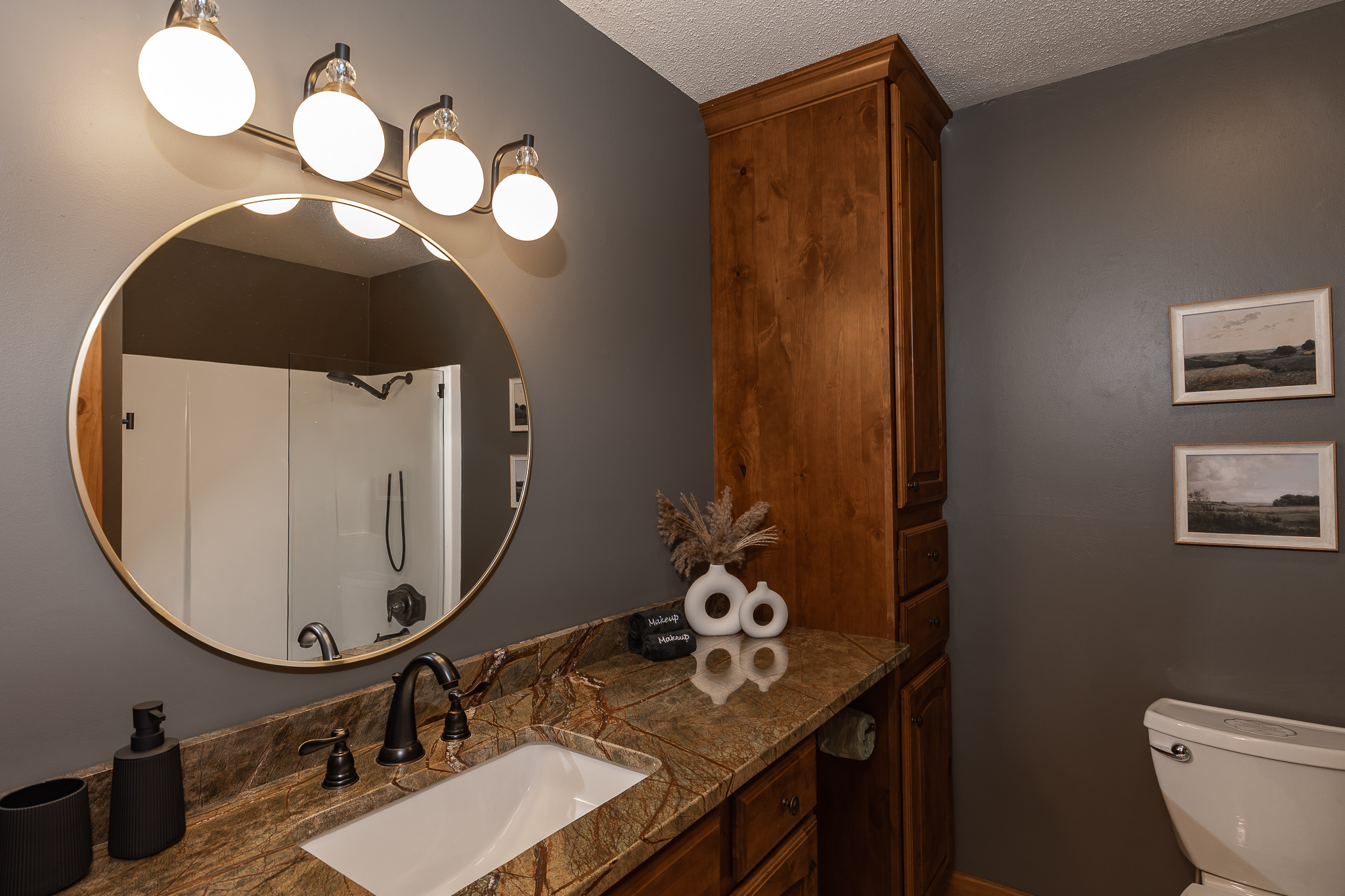 {Bathroom 3} A spacious vanity, oversized mirror, and full tub and shower make this bathroom comfortable and functional for group stays.