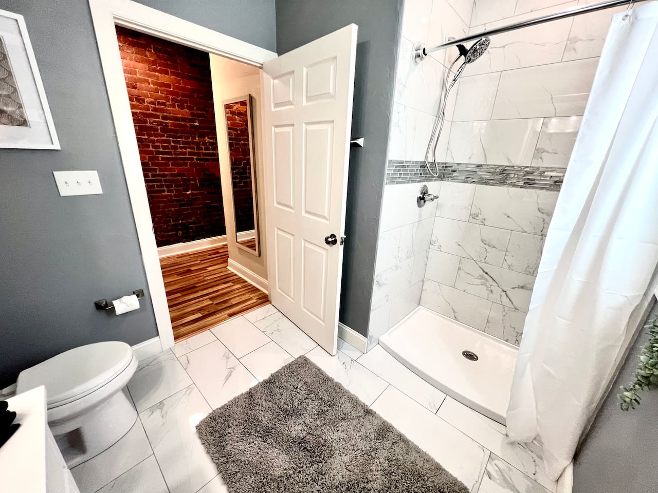 Bathroom featuring a toilet and shower, designed for your comfort and convenience.