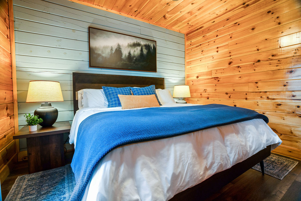 Crisp white linens and cozy textures in this king located on the main level