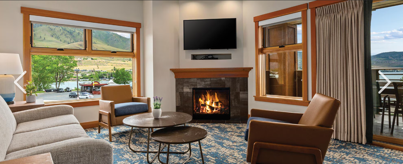 Open living room with TV, fireplace, lake view and with pull out couch