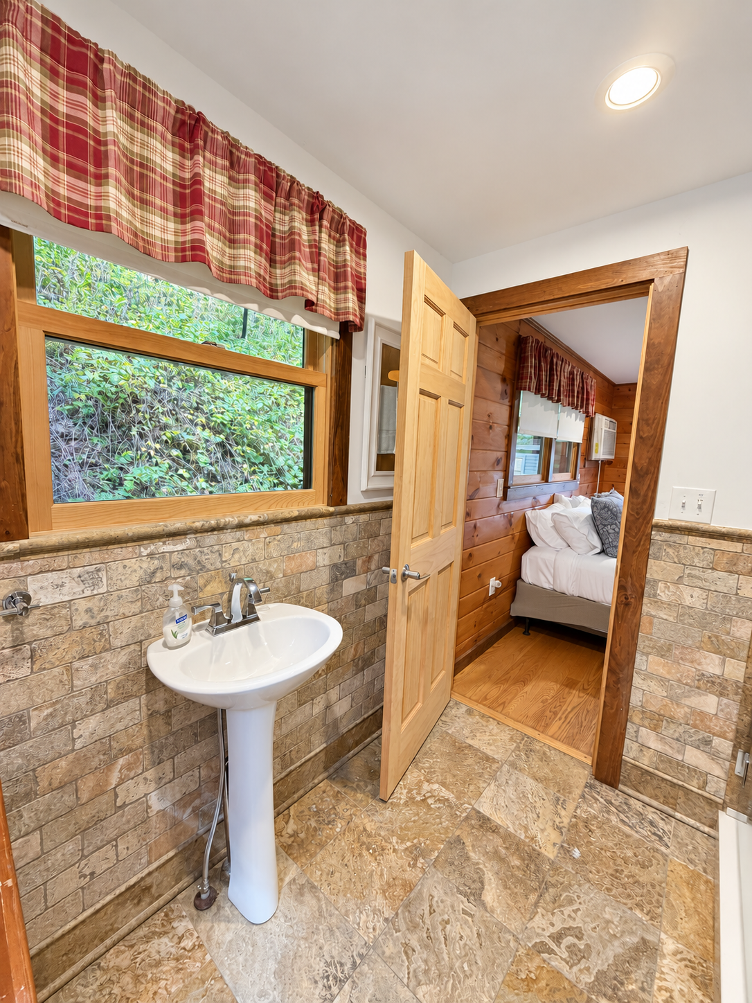 Bathroom with wide tiled shower and frame-less glass surround