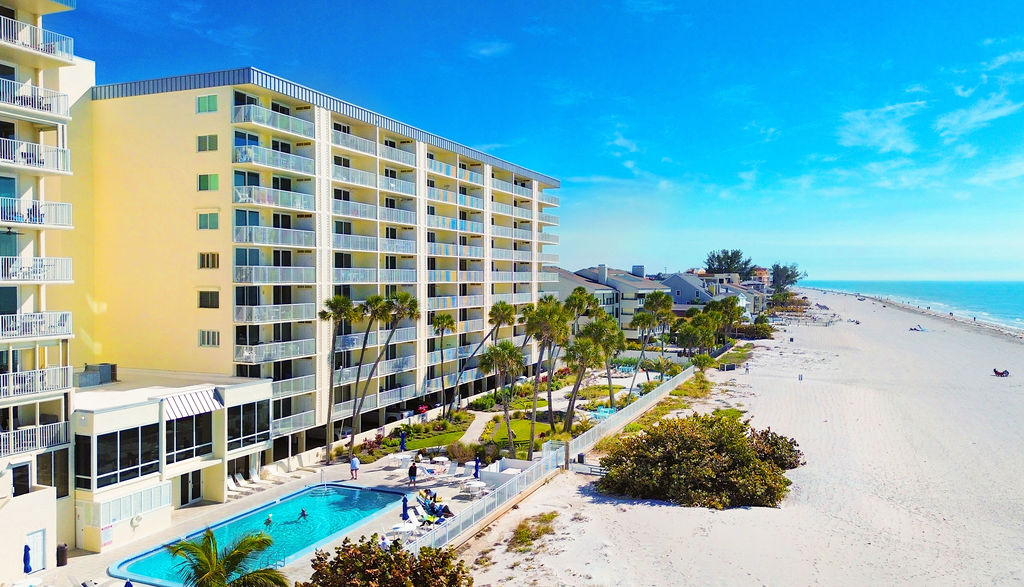 Beachfront vacation rental with private balconies, resort-style pool, and direct access to pristine white sand beaches.