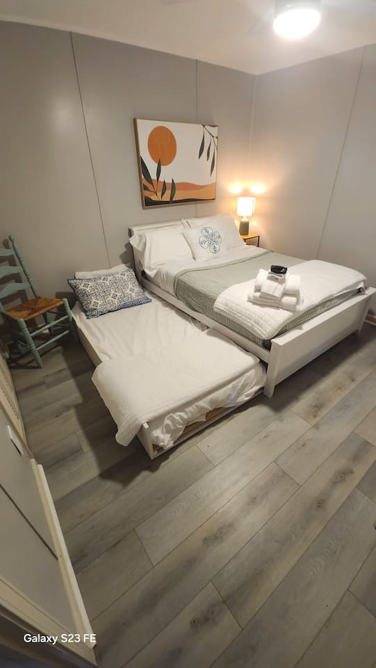 bedroom 2 with full size bed and twin bed with flat screen tv.