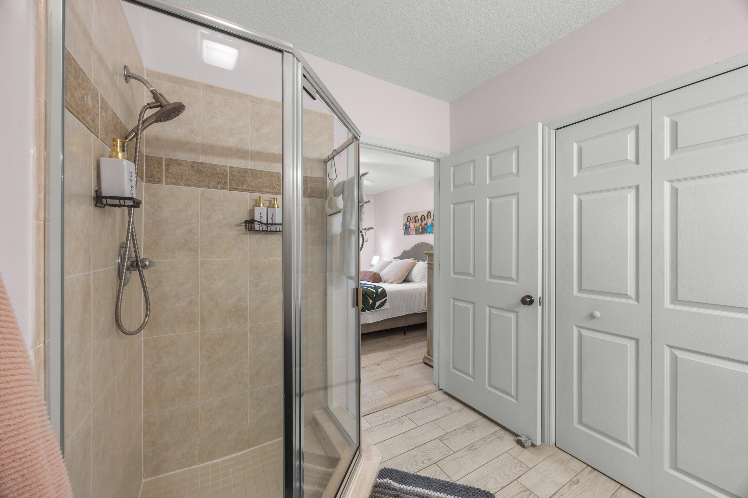 Step into a fresh and modern ensuite with a glass walk in shower.