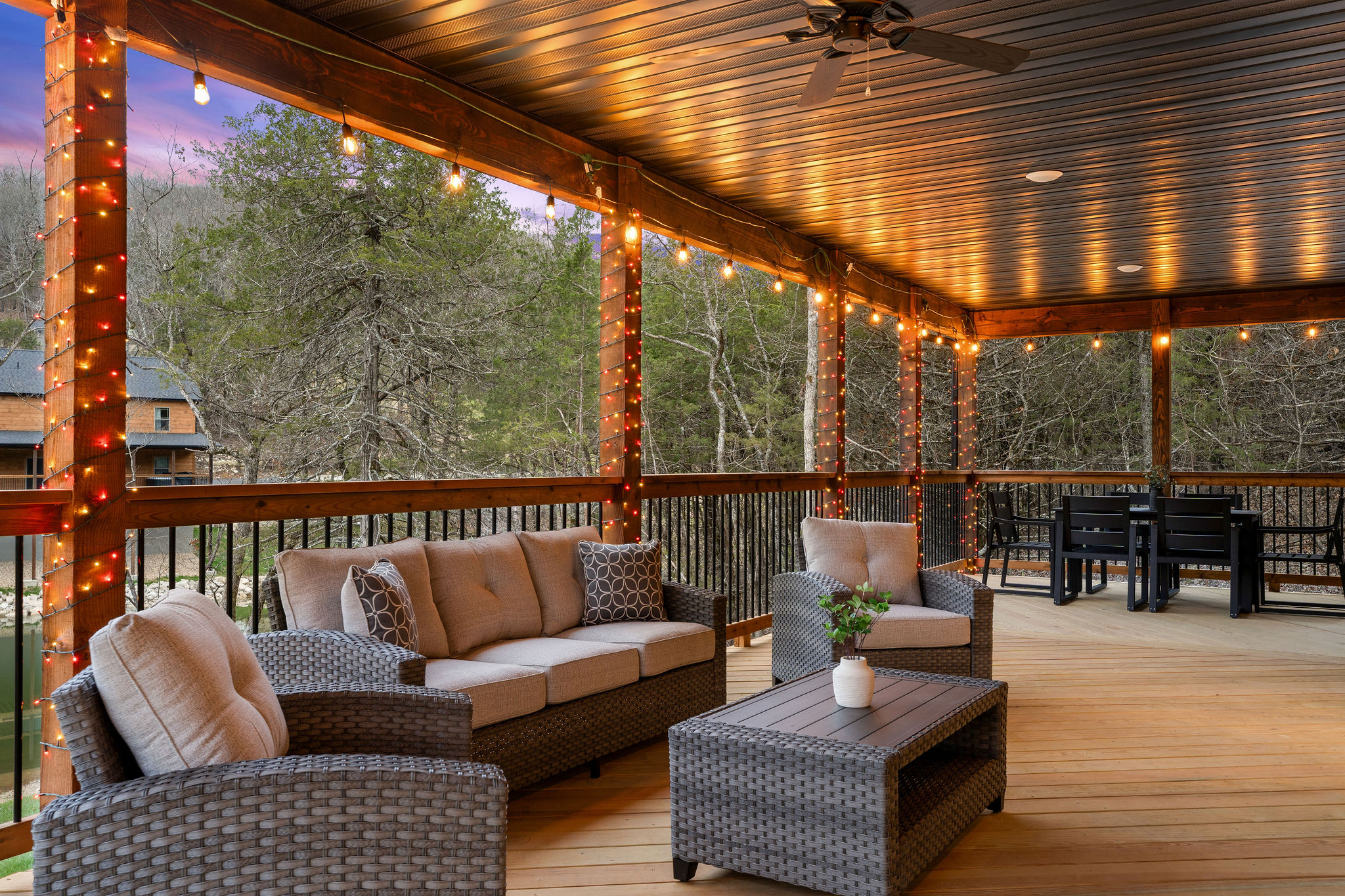 Relaxed outdoor lounge space surrounded by peaceful wooded views.