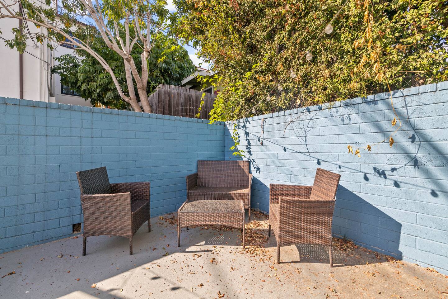 Charming exterior featuring four aesthetic chairs surrounding a stylish table, creating an inviting outdoor seating area. This lovely setup is perfect for enjoying morning coffee or relaxing in the fresh air, enhancing the home’s welcoming atmosphere