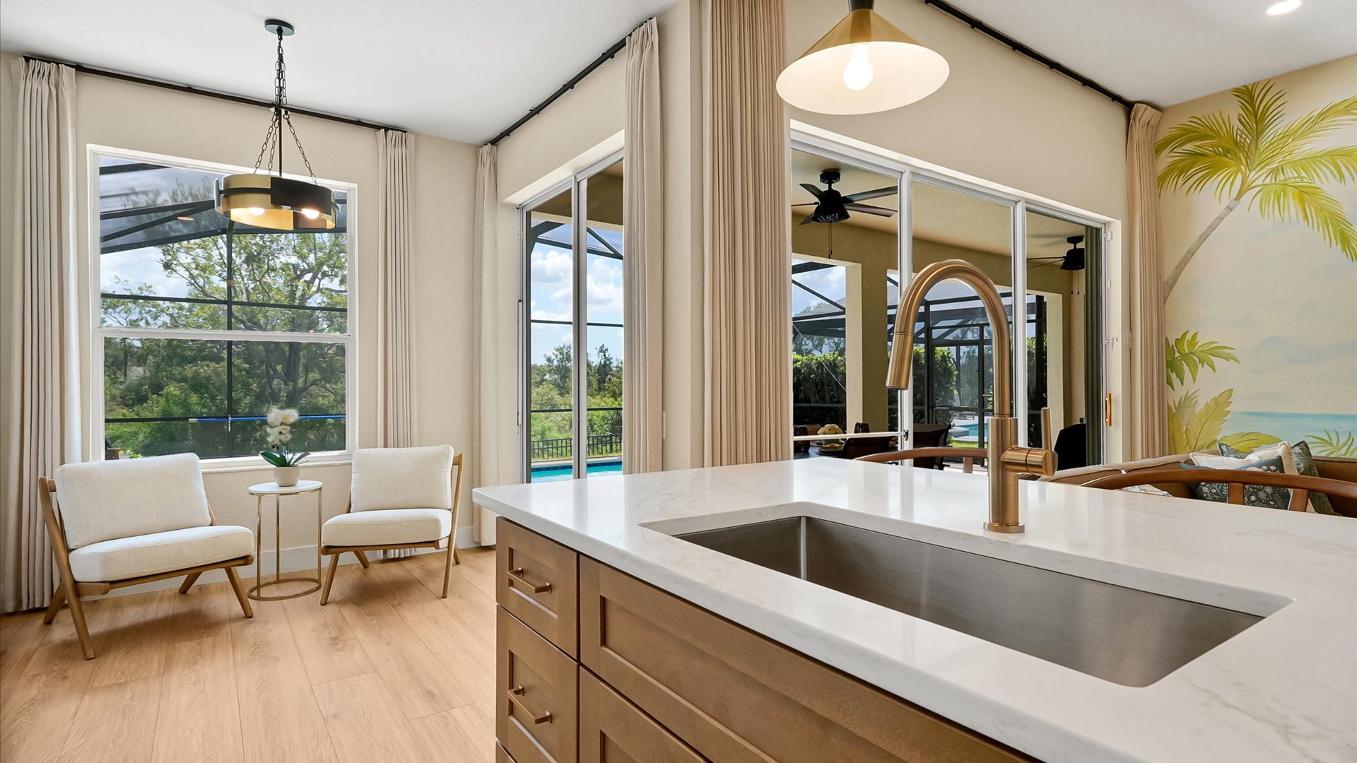 Kitchen: Oversized island with a deep sink, pool views and an adjoining sitting area.