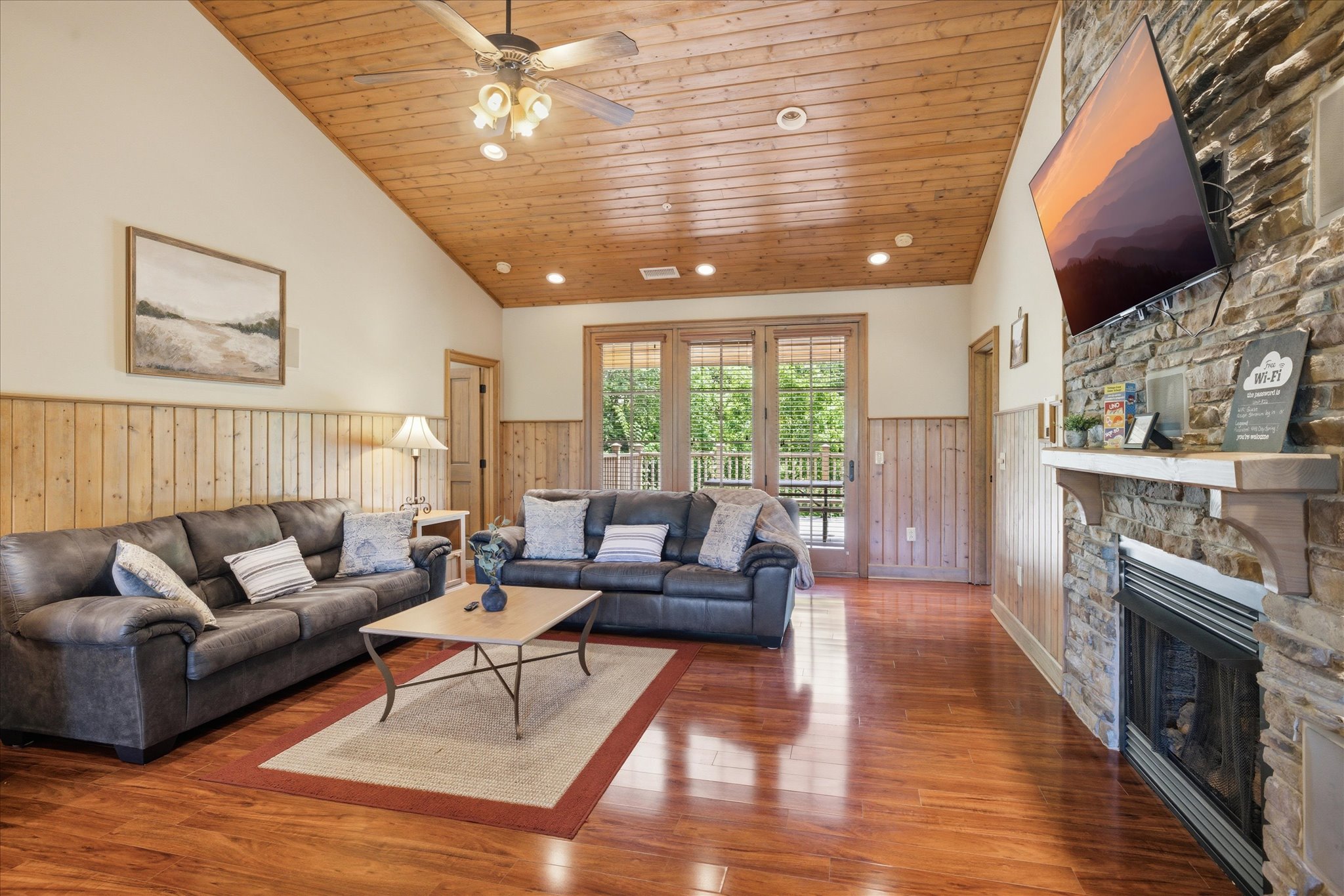 Settle into the living area in Unit 322 with comfortable seating, a large TV, and an easy flow into the rest of the space.