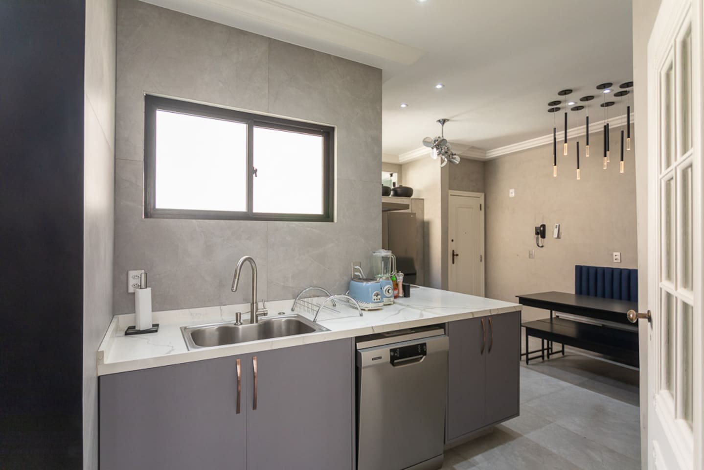 Fully stocked kitchen with table and seating.