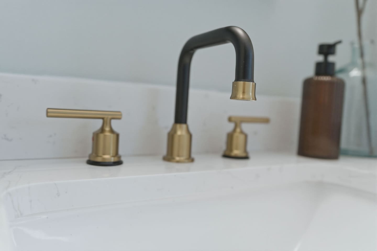 Sleek vanity faucet with modern black and gold finishes, adding a touch of elegance to your daily routine
