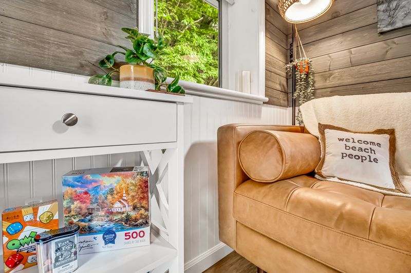 A welcoming space filled with natural light, comfortable seating, and a selection of board games. Perfect for relaxing after a day of spring adventures and outdoor exploring.