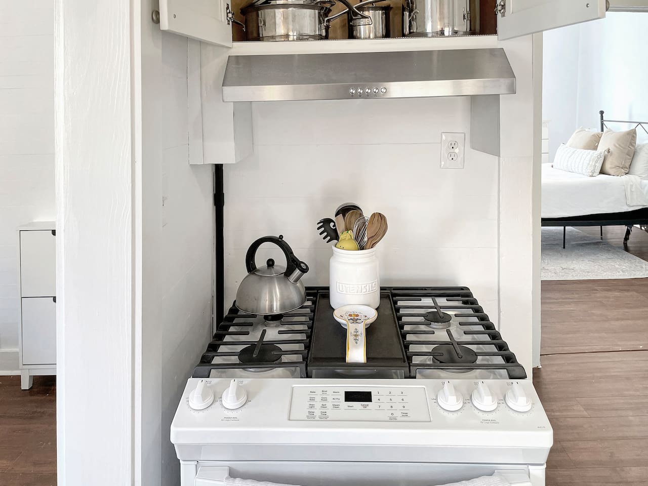 Gas stovetop with all the pots and pans to cook up a meal.