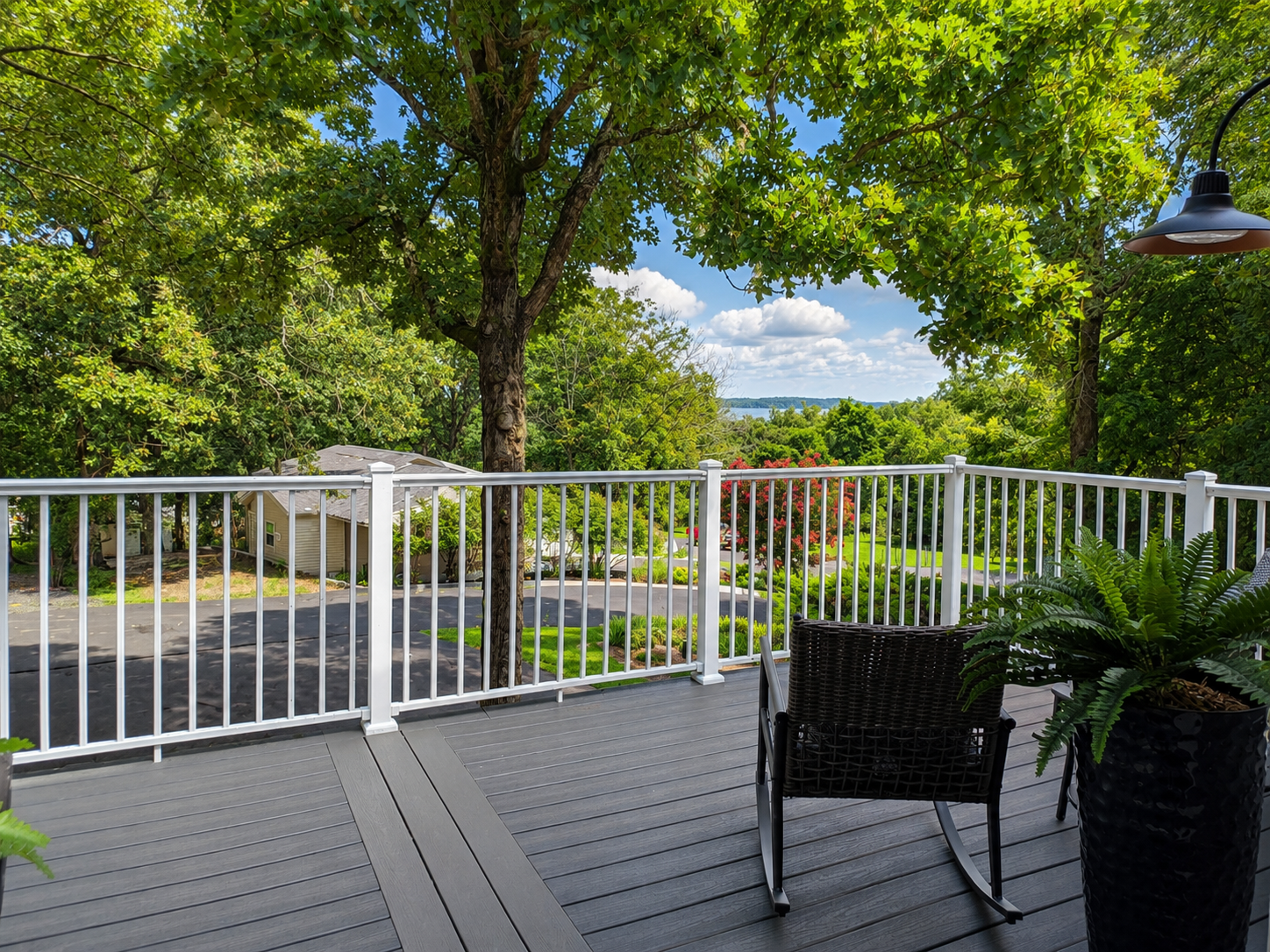 Upper-level deck with peaceful lake views, outdoor seating and a relaxing spot to enjoy the wooded setting.