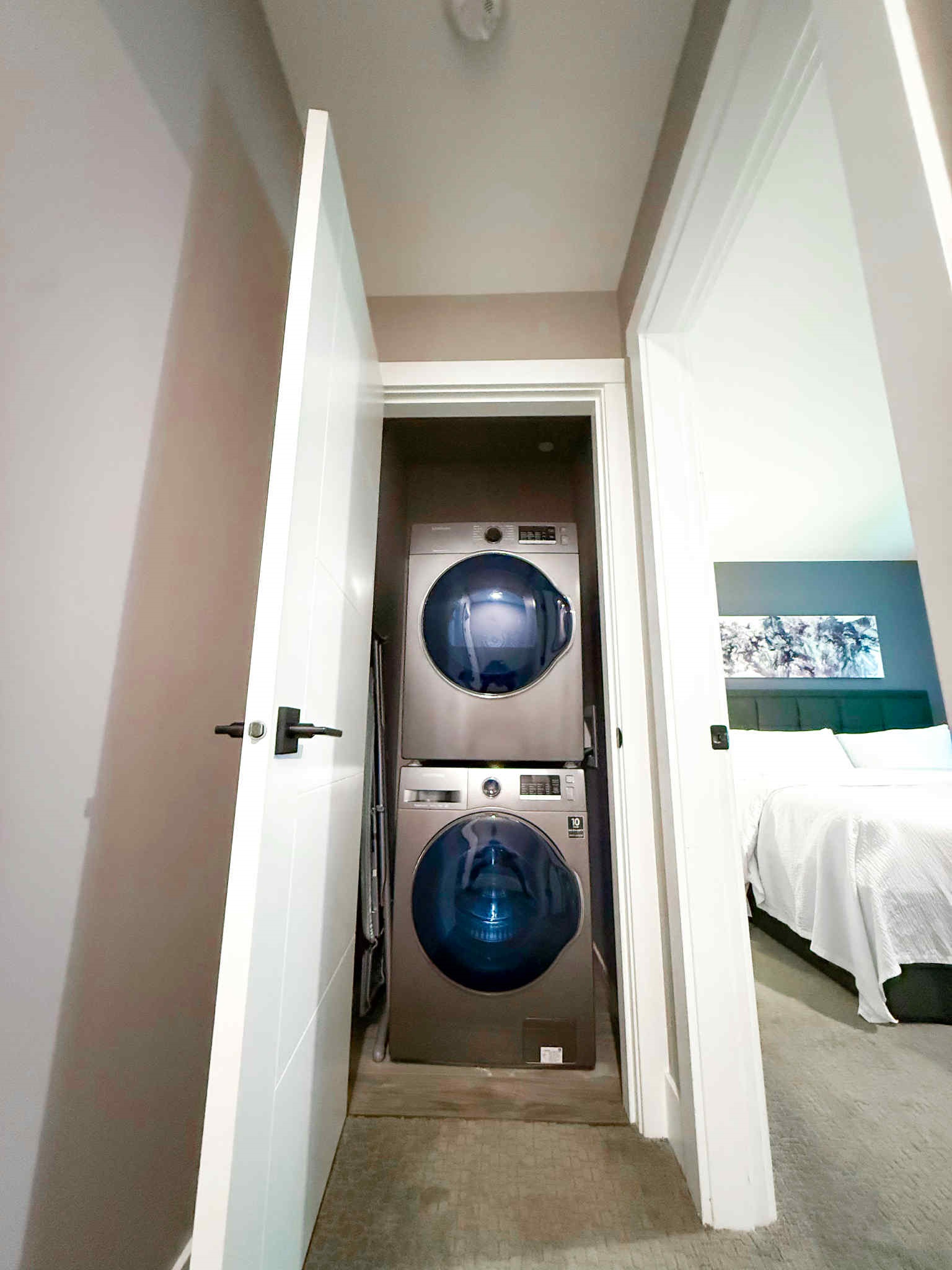 Stackable Washer and Dryer. Also, ironing board and vacuum kept in Laundry Area.