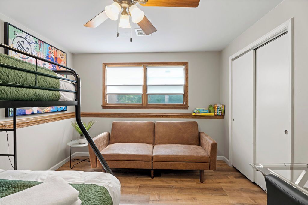 Pile the whole gang in this efficiently furnished bedroom featuring a futon bed!
