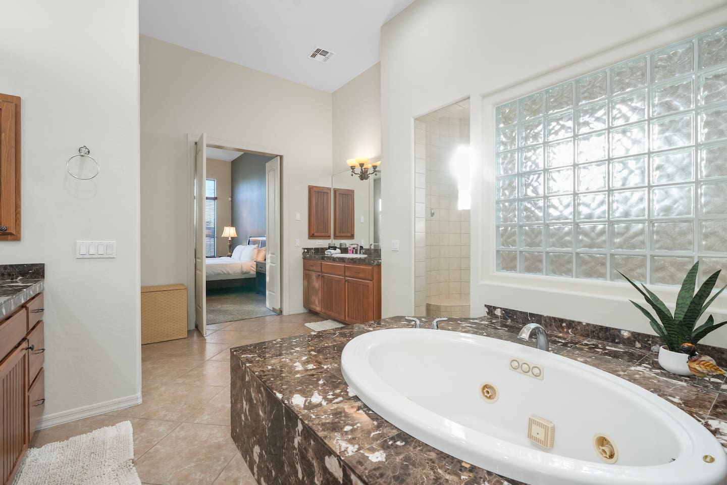 Luxurious soaking tub set in marble-style stone for ultimate relaxation.