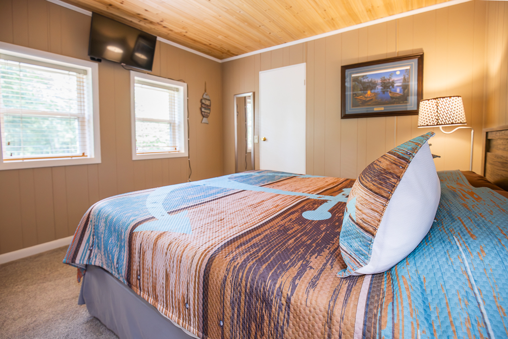 Relax in this peaceful bedroom retreat, complete with soft natural light, warm wood finishes, and a comfy king bed for a restful night’s sleep.