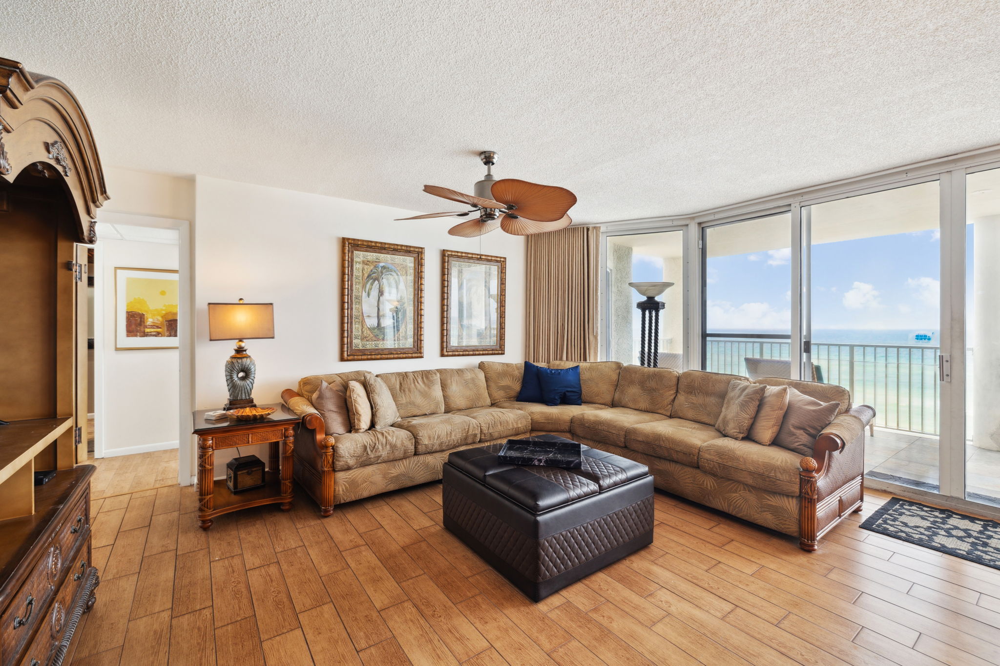 Living room with panoramic views of the beach and balcony