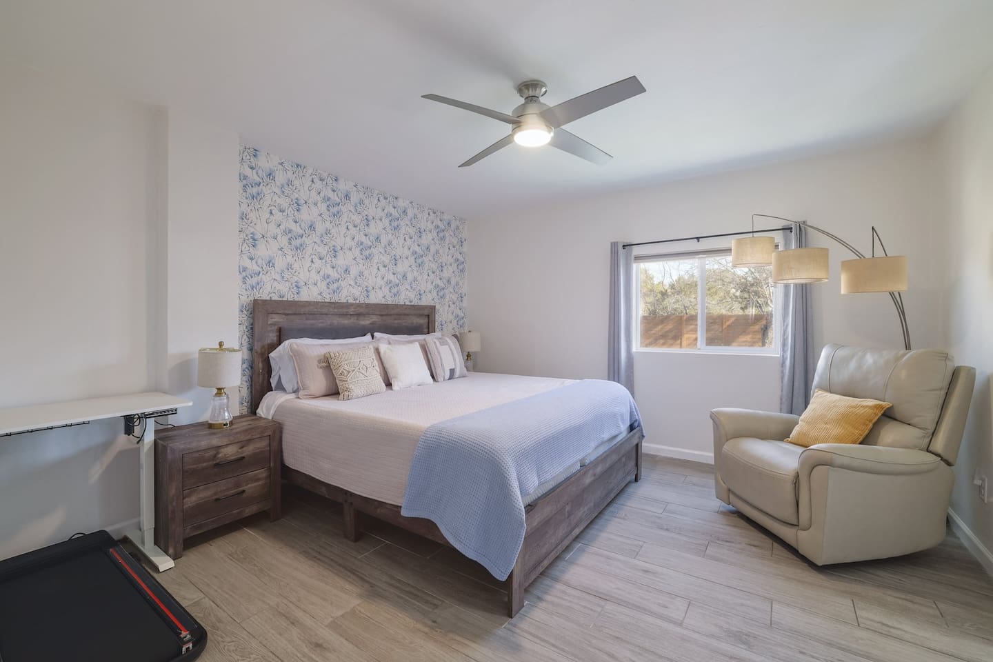 Retreat to this spacious downstairs king suite, where soft textures, calming tones, and a cozy reading corner create the perfect place to unwind. Designed for restful mornings and deep, comfortable sleep.