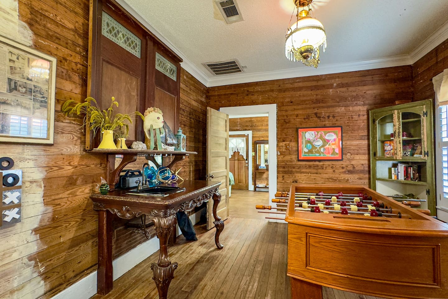 Spacious recreation room with a foosball table, games, and cozy seating—great for all ages to unwind and have fun.