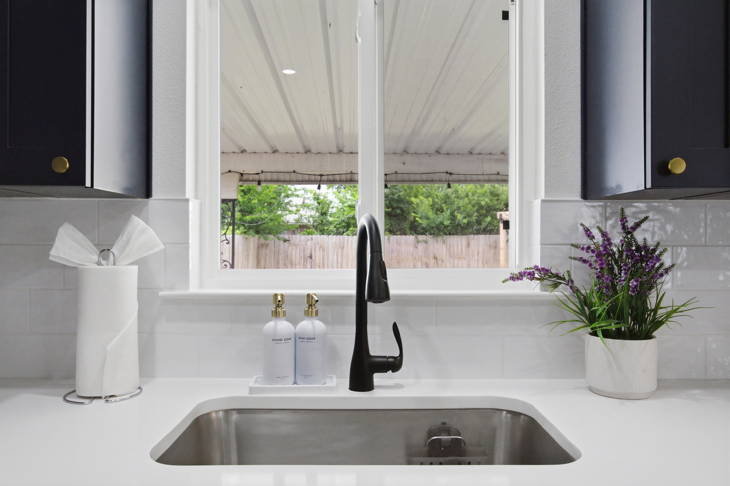 Kitchen with deep Stainless Sink, window view, and convenient countertop space. Dish Soap, sponges, and Basic Cleaning Products provided for the stay.
