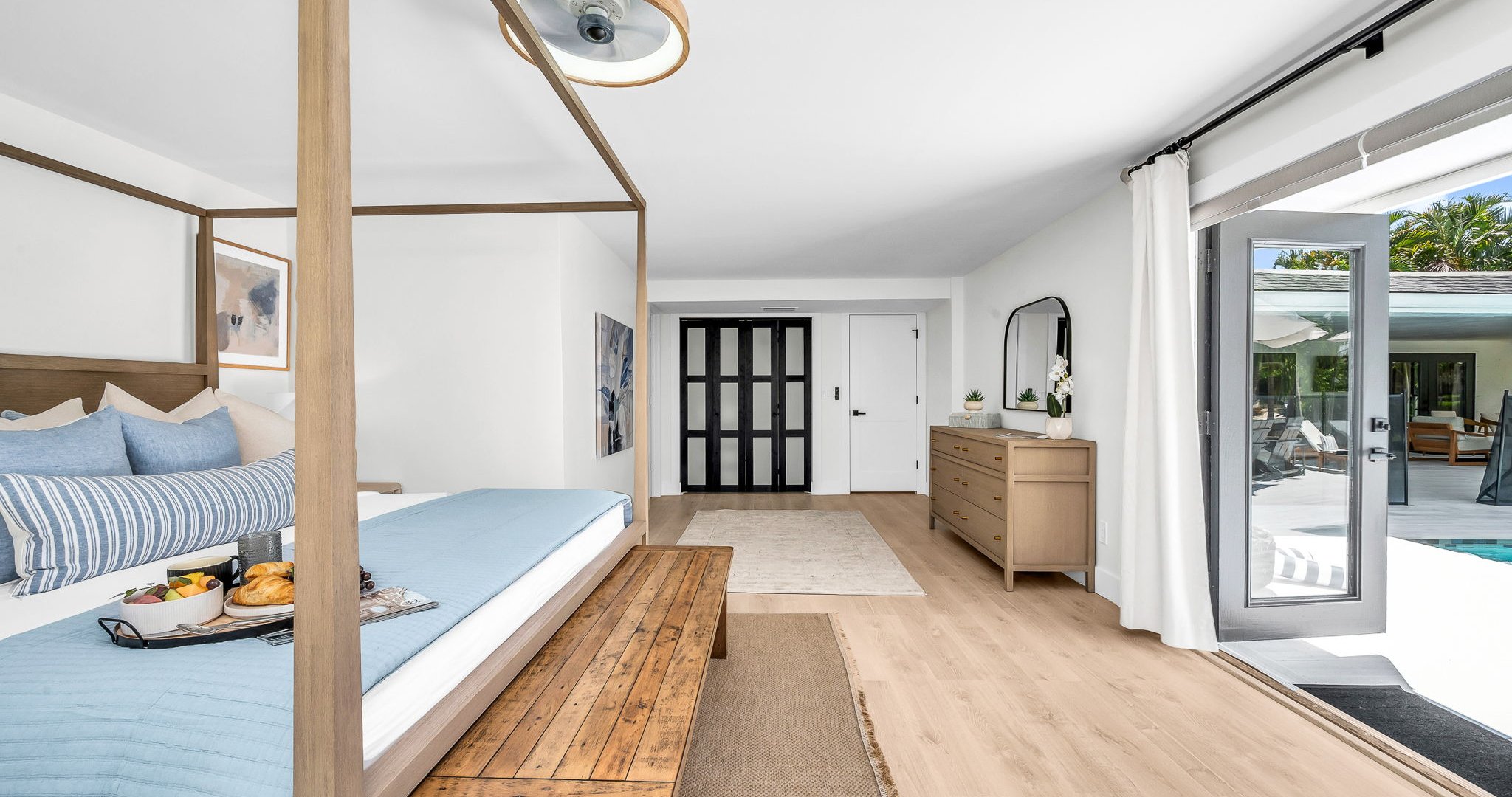 The primary king suite feels like your own private resort—featuring panoramic views of the pool and lake, seamless indoor-outdoor flow, and a newly renovated spa-inspired ensuite. Thoughtfully styled with designer finishes.
