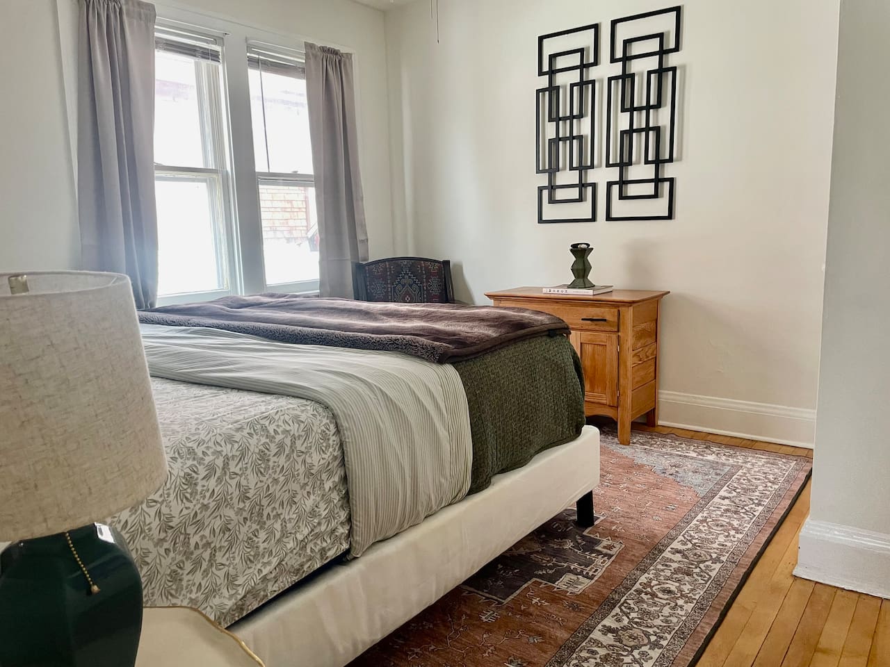 King bedroom with plush bedding, layered textures, and warm lighting—an inviting retreat for deep, restful sleep.