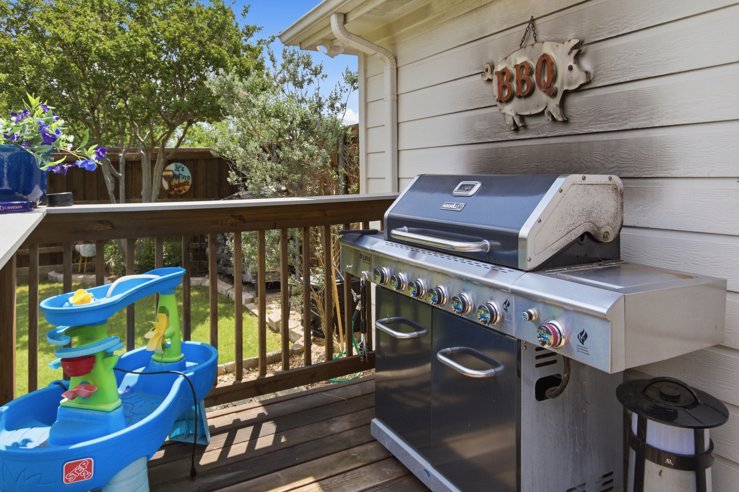 Propane BBQ Grill with BBQ utensils plus a kid-friendly Children's Water Table on the Deck. Wall-mounted Outdoor Fan keeps the whole family cool on warm Texas afternoons.
