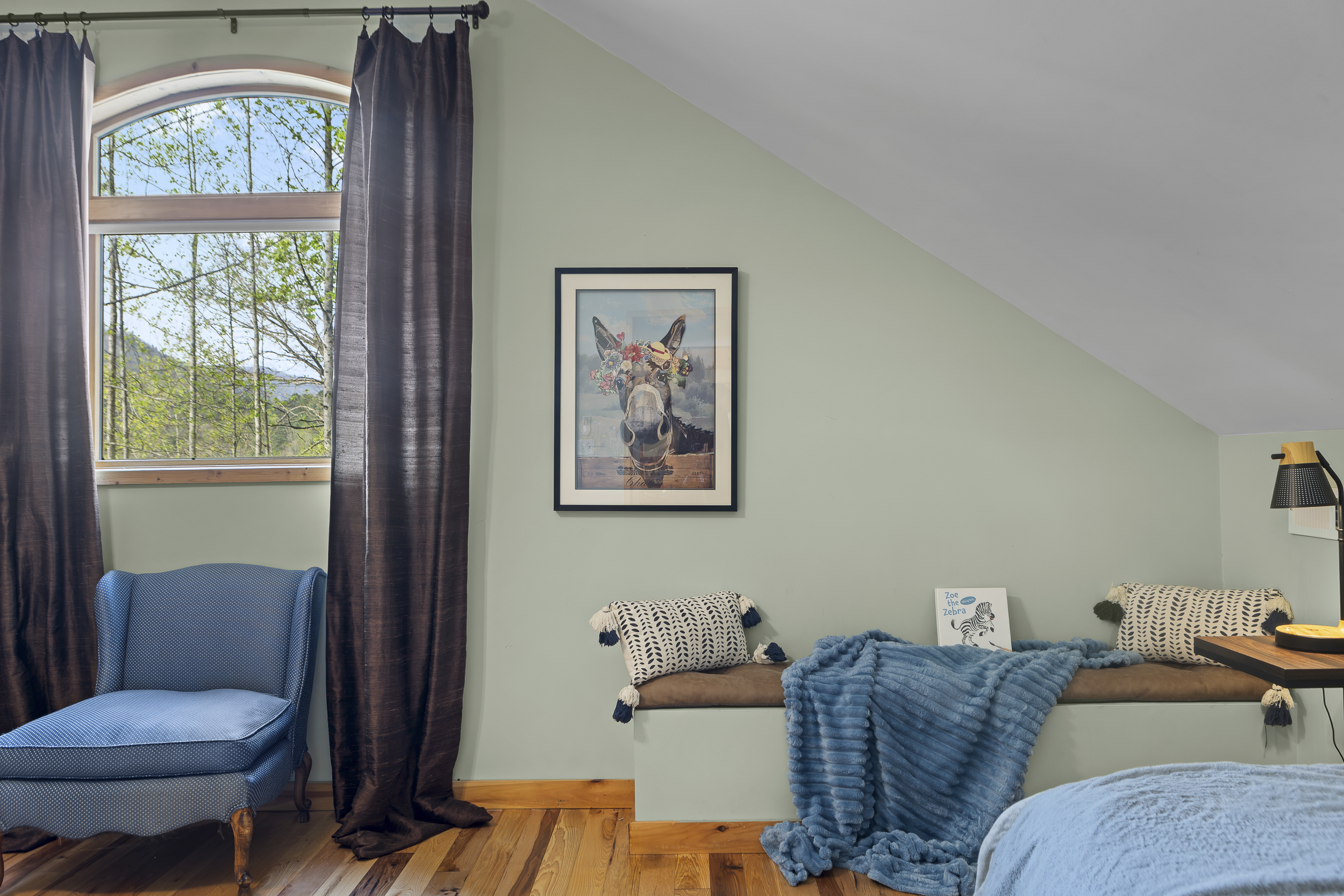 Queen Bedroom 3: Bright room with scenic views, comfy seating, and whimsical decor awaits!