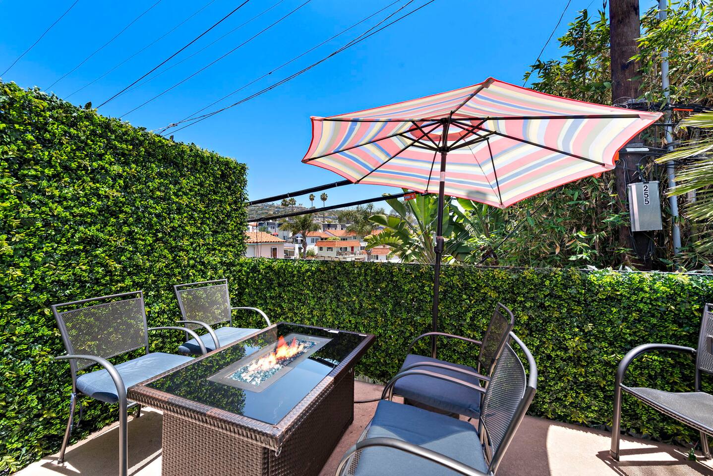 The private outdoor patio has a gas grill and chairs. This balcony almost counts as shared space as you will likely hear the guests below in the backyard