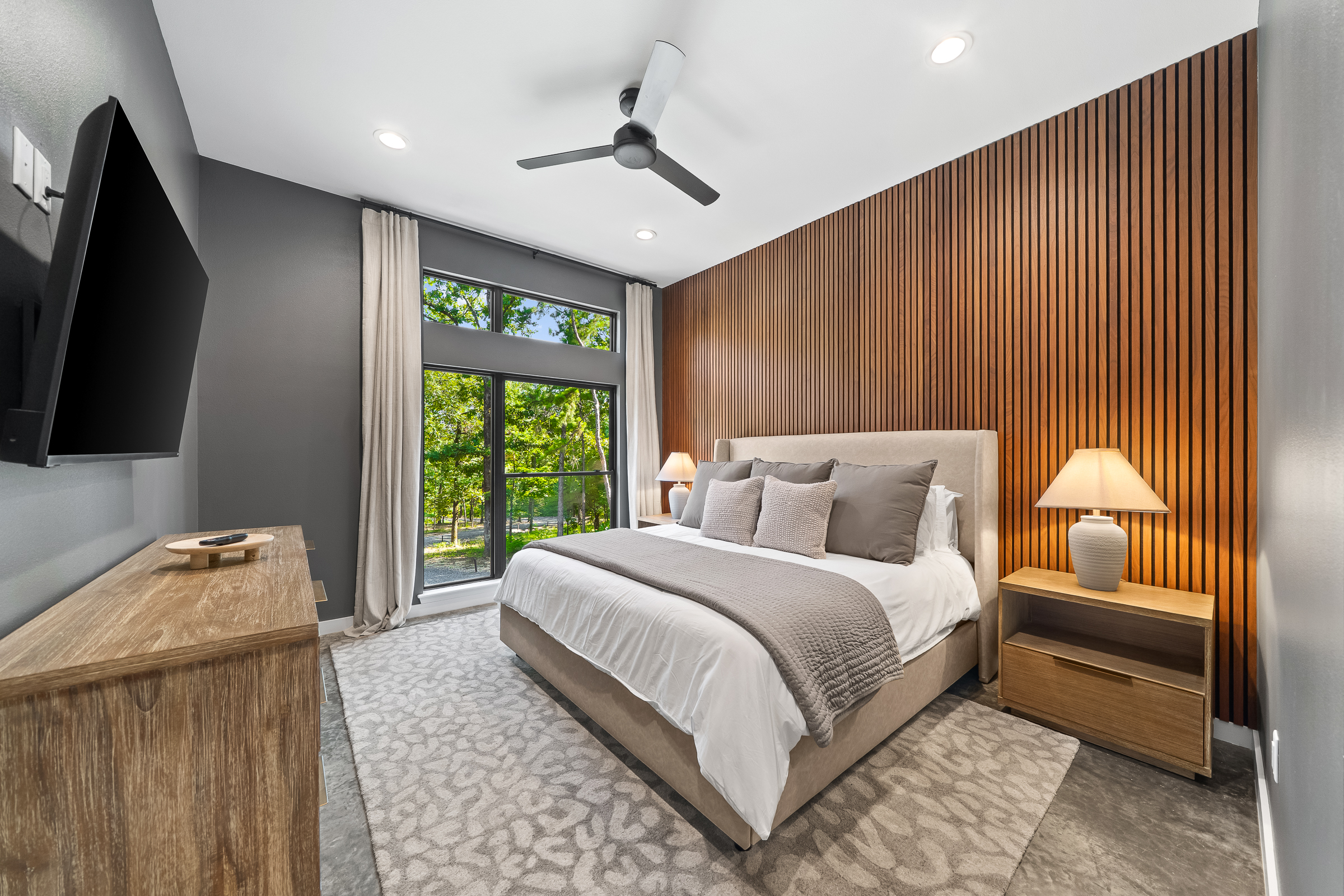 King Suite 1 - Large and spacious suite with teak wood paneling, smart TV, premium king mattress, and luxury bedding. Includes stunning views of the hardwood forest. 