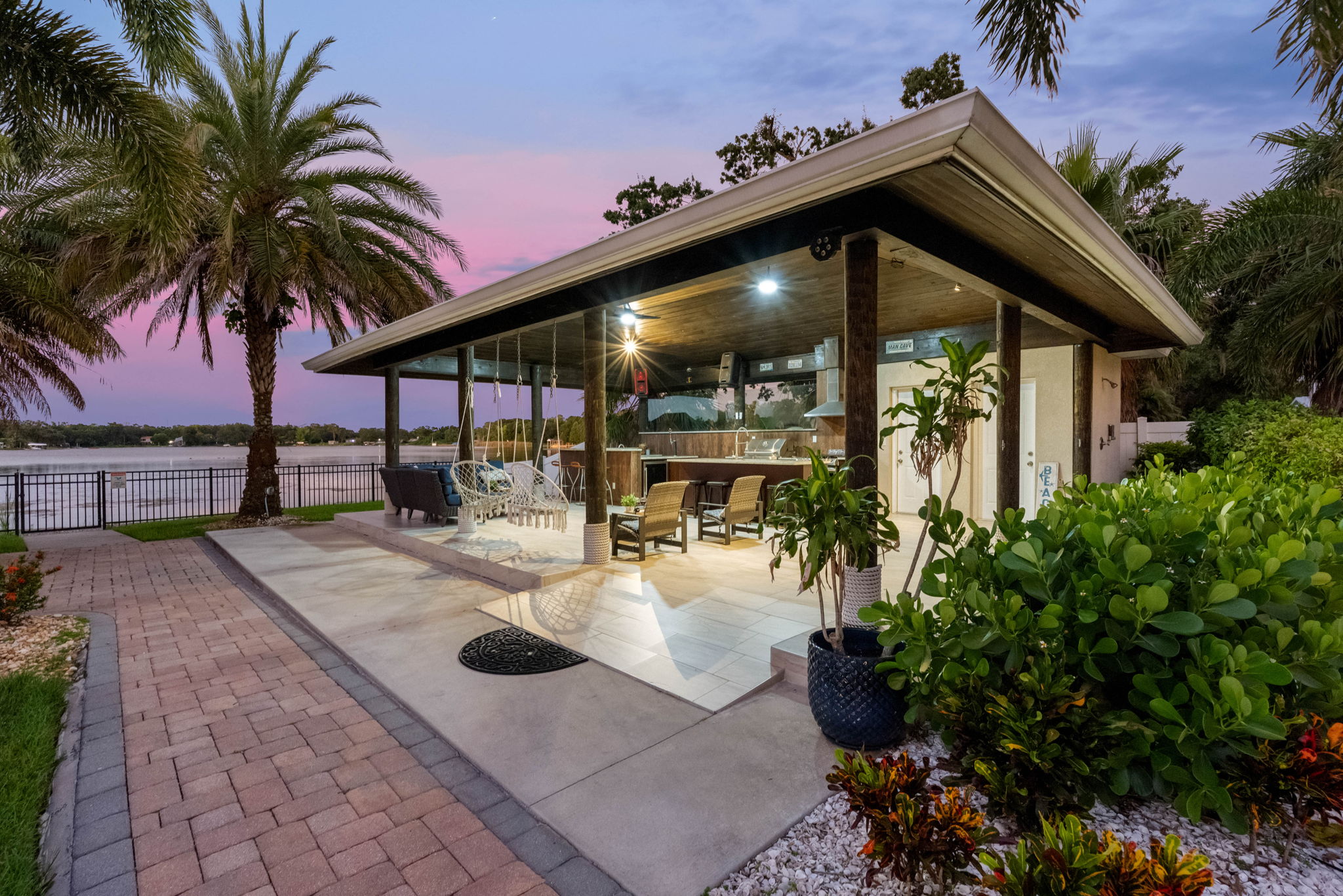 Host unforgettable nights in this pavilion featuring a chef’s grill, bar seating, and lounge areas against a stunning sunset backdrop.