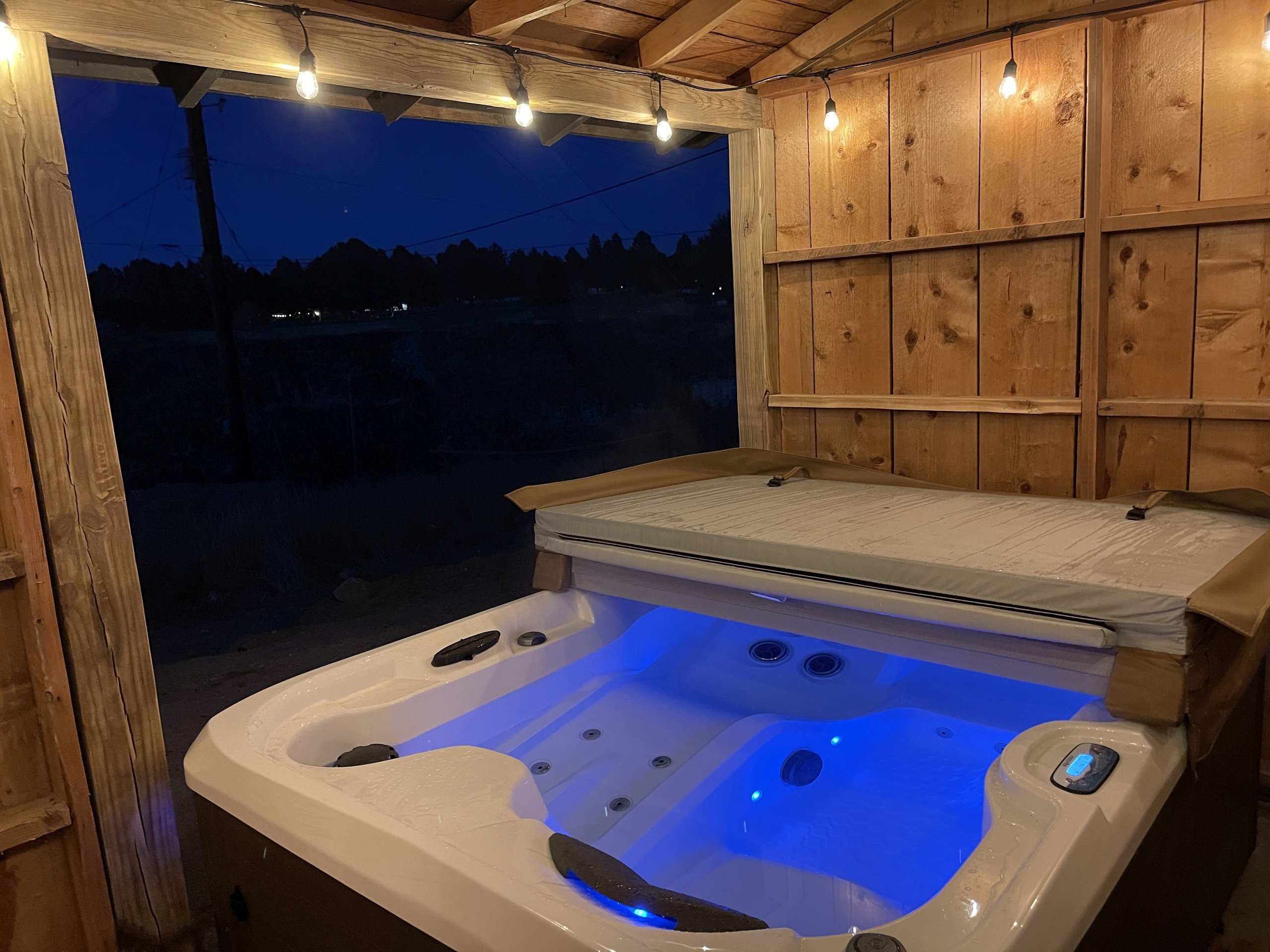 Soak beneath the canyon stars — the hot tub glows at night