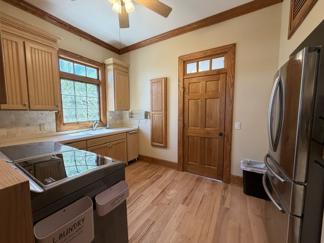 Laundry Room 1st Level with 2nd Refrigerator, sink and pull down ironing board.  