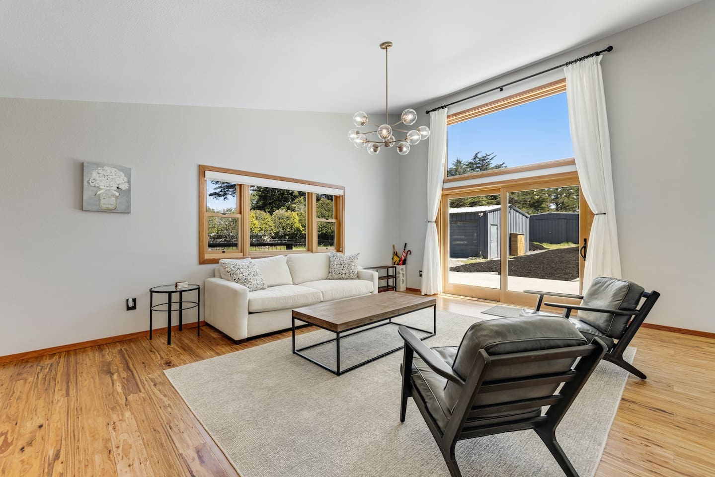 Relax in the bright living space with expansive windows.