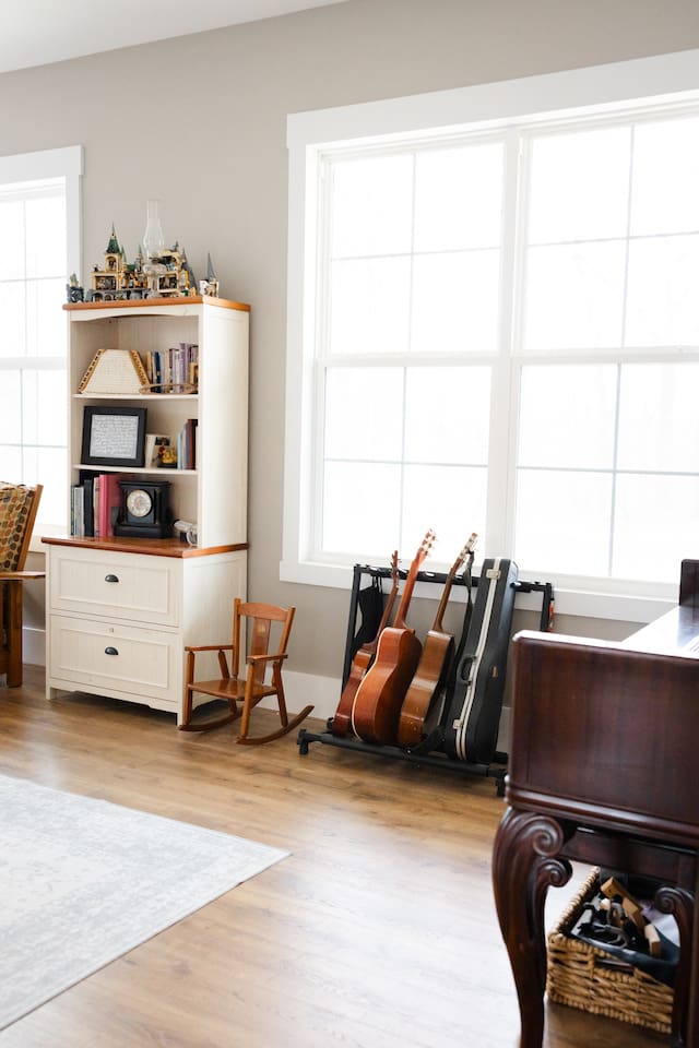 Our library features three work spaces, two comfy chairs for reading, PLENTY of books (we love the classics!), children's art supplies & crafts, as well as a piano and a few guitars. Beautiful views from these windows too. Open to living room/foyer.