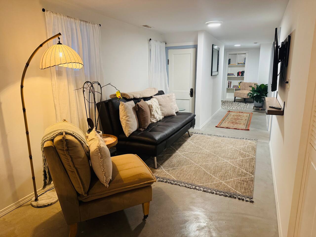 Second cozy living room with leather sofa that easily converts into a comfortable bed  — perfect for additional guests. Fresh linens and bedding are provided for easy setup.