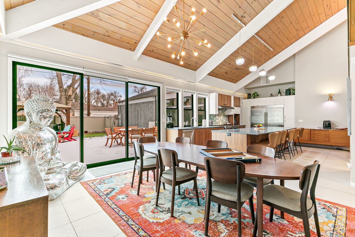 The dining area comfortably seats nine guests, featuring an expandable table and a two-sided fireplace. Its proximity to the fully equipped kitchen, Living Room 1, and the Back Patio adds convenience to mealtimes and social gatherings.